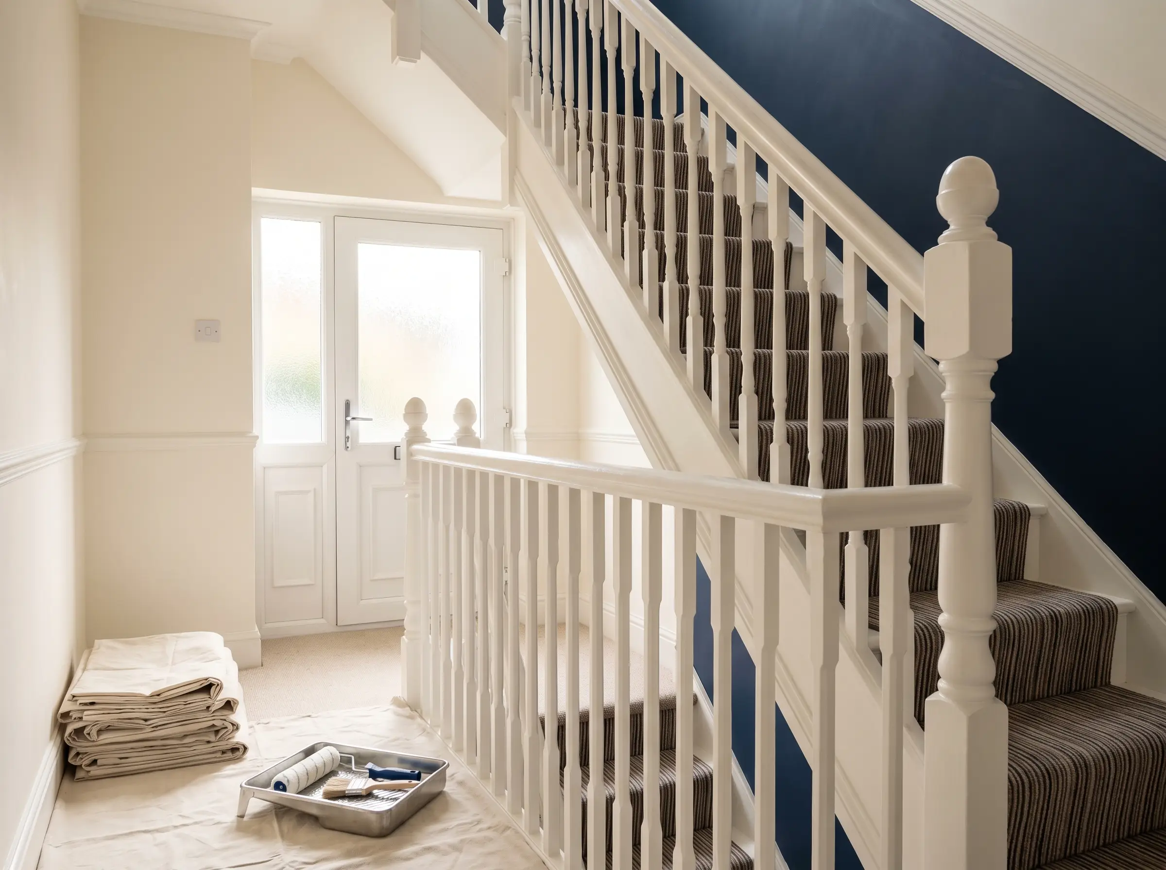 A professionally decorated hallway and staircase with crisp paintwork